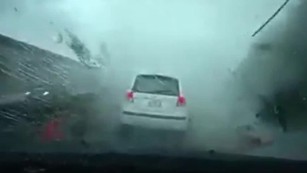 Watch a typhoon blow this car away