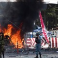 Afghan security forces shout as they keep watch at the site of a huge blast struck near the entrance of Kabul&#39;s international airport, in Kabul on August 10, 2015. A huge blast struck near the entrance of Kabul&#39;s international airport on August 10 during the peak lunchtime period, officials said, warning that heavy casualties were expected. &quot;The explosion occurred at the first check point of Kabul airport,&quot; said deputy Kabul police chief Sayed Gul Agha Rouhani.