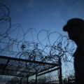 A Public Affairs Officer escorts media through the currently closed Camp X-Ray which was the first detention facility to hold 'enemy combatants' at the U.S. Naval Station on June 27, 2013 in Guantanamo Bay, Cuba.