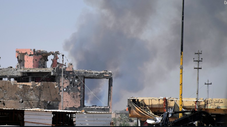 Smoke rises above a damaged building following a U.S.-led coalition airstrike against ISIS positions during a military operation to regain control of the eastern suburbs of Ramadi, Iraq, on Saturday, August 15.