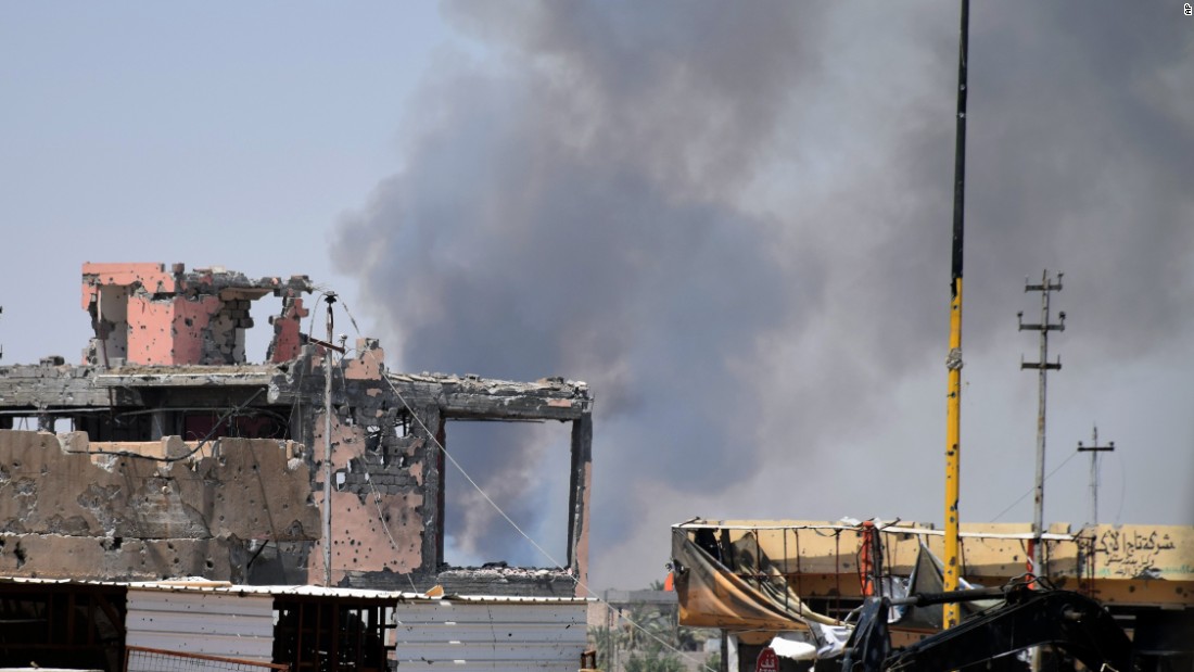 Smoke rises above a damaged building following a U.S.-led coalition airstrike against ISIS positions during a military operation to regain control of the eastern suburbs of Ramadi, Iraq, on Saturday, August 15.