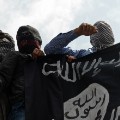Kashmiri demonstrators hold up a flag of the Islamic State of Iraq and the Levant (ISIL) during a demonstration against Israeli military operations in Gaza, in downtown Srinagar on July 18, 2014. 