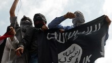 Kashmiri demonstrators hold up a flag of the Islamic State of Iraq and the Levant (ISIL) during a demonstration against Israeli military operations in Gaza, in downtown Srinagar on July 18, 2014. 