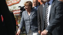 HEIDENAU, GERMANY - AUGUST 26: German Chancellor Angela Merkel arrives to visit the aslyum shelter that was the focus of recent violent protests on August 26, 2015 in Heidenau, Germany. Onlookers booed as she arrived and right-wing demonstrators clashed violently with police last weekend near the shelter. This is Merkel&#39;s first visit to a shelter for migrants seeking asylum in Germany. Germany is expecting to receive at least 800,000 migrants and refugees this year and is struggling to house them and process their asylum applications. (Photo by Sean Gallup/Getty Images)