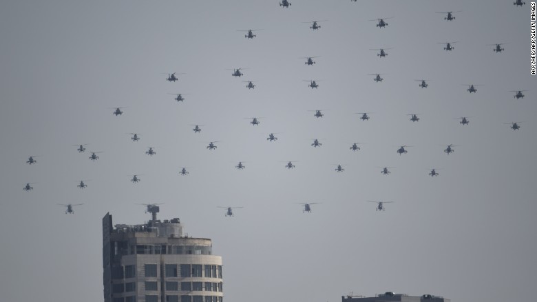 Chinese military helicopters fly in formation during the grand parade on September 3.