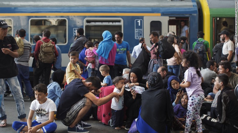Migrants stand on the platform of the Keleti station waiting for a train. The station has become a focal point of the crisis currently engulfing parts of Europe, as an unprecedented wave of people -- mostly refugees fleeing conflict in Syria, Iraq and Afghanistan -- seek to reach Northern and Western Europe.