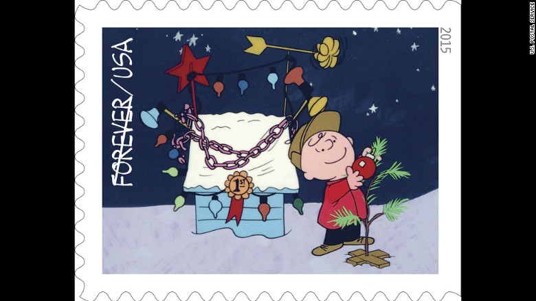 Charlie Brown decorates his tree by the prize-winning lights on Snoopy's doghouse. 