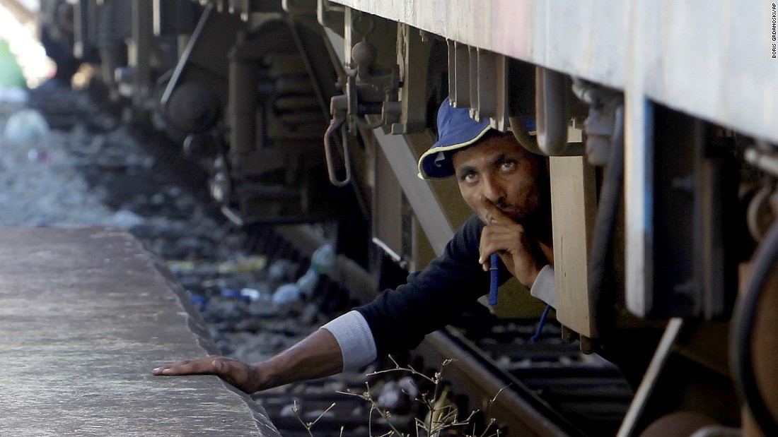 A migrant in Gevgelija, Macedonia, tries to sneak on a train bound for Serbia on Monday, August 17. More than 1,000 migrants enter Macedonia daily from Greece, heading north through the Balkans on their way to more prosperous countries in the European Union.