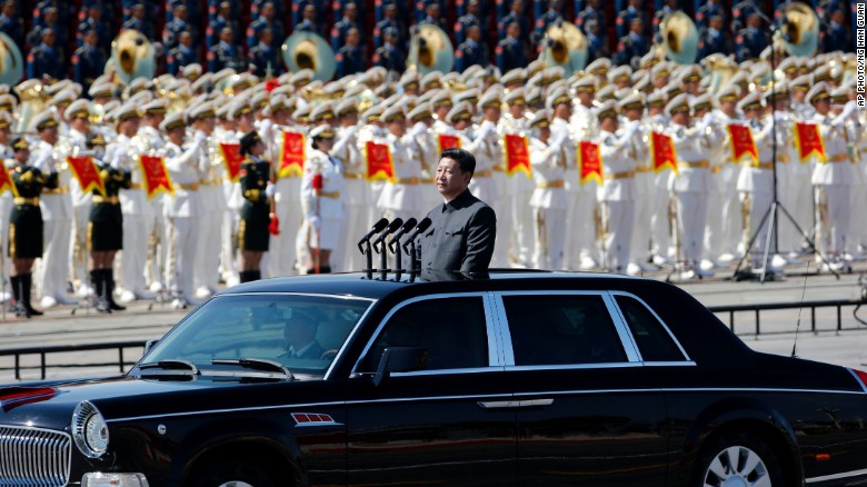 Chinese President Xi Jinping stands in a sedan to address the People&#39;s Liberation Army on September 3.