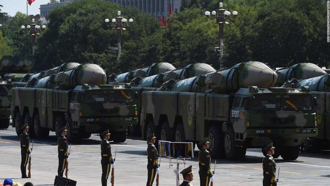 Military vehicles carrying DF-21D missiles, also known as the"carrier-killer" are displayed in a military parade at Tiananmen Square in Beijing on September 3, 2015.