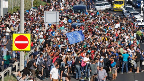 http://i2.cdn.turner.com/cnnnext/dam/assets/150904172147-migrants-walk-from-budapest-large-169.jpg