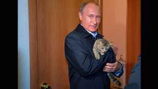 Russian President Vladimir Putin holds a cat as he inspects housing built for victims of wildfires in the village of Krasnopolye, in a region in southeastern Siberia, Russia, on Friday, September 4. For years, Russia&#39;s leader has cultivated a populist image in the Russian media.