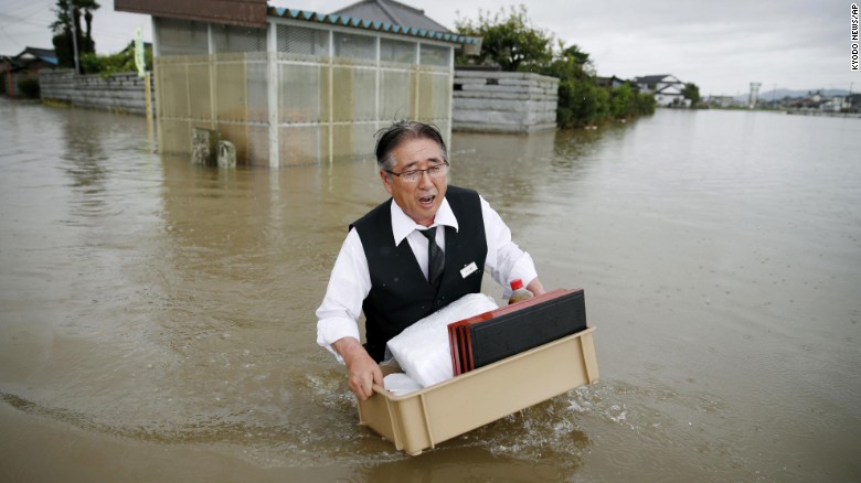 Japan flooding: Houses swept away, residents stuck on roofs