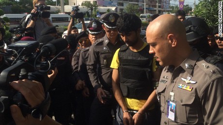  Yusufu Meerailee, one of the suspects, wears a bulletproof vest as he is escorted by Thai authorities.