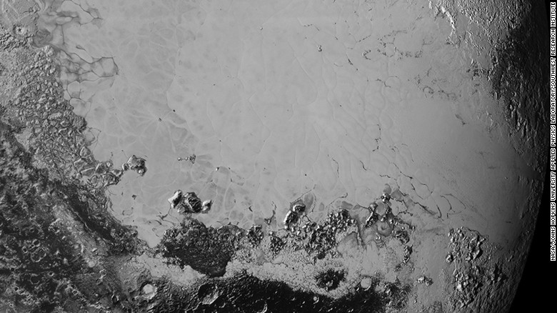 Scientists say that what looks like mountains could be huge blocks of frozen water suspended in frozen nitrogen. On the new photos, taken on July 14 and released on September 10, a pixel is 400 meters (440 yards). New Horizons&#39; closest pass by Pluto took it about 50,000 miles from the surface.