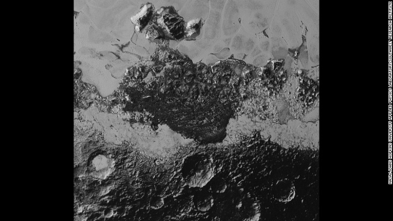 Pluto&#39;s landscape has lots of variety -- plains, mountains, craters, and what looks like they might be dunes. The smallest details on the photos are about 0.5 miles wide. The area with the craters is ancient, scientist say. The smooth frozen planes are relatively young.
