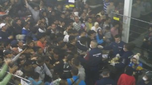 Police throw food to desperate refugees