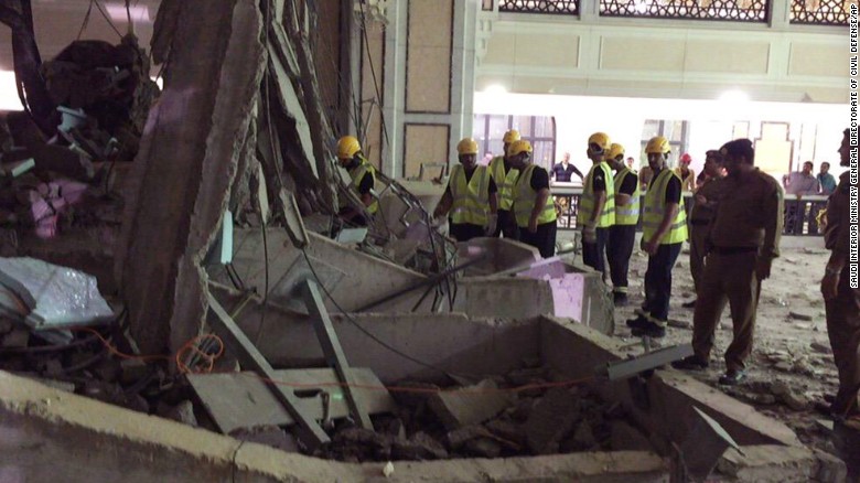 Civil Defense personnel inspect the damage at the mosque.