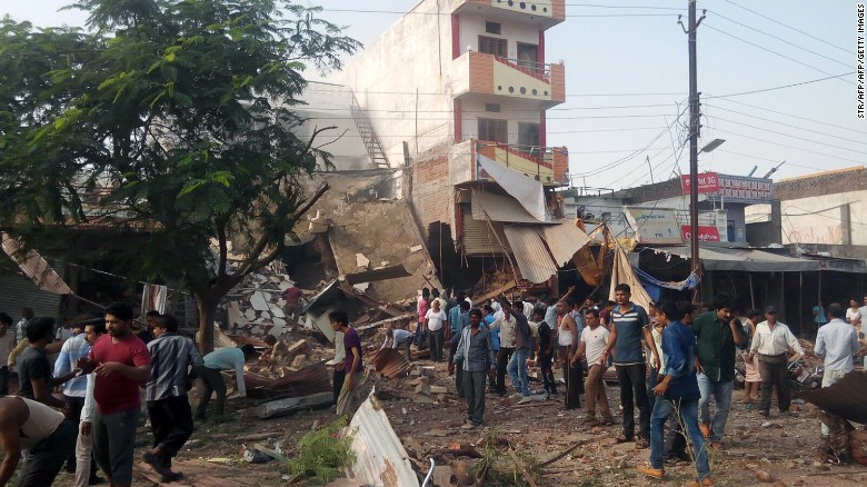 People gather around the site of a deadly explosion in the central Indian state of Madhya Pradesh on Saturday.