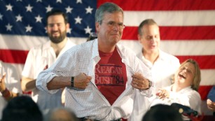 MIAMI, FL - SEPTEMBER 12:  Republican presidential candidate and former Florida Governor Jeb Bush shows off a Reagan/Bush '84 tee-shirt as he speaks during a Miami field office opening on September 12, 2015 in Miami, Floria. Bush continues to campaign for the Republican nomination.  (Photo by Joe Raedle/Getty Images)