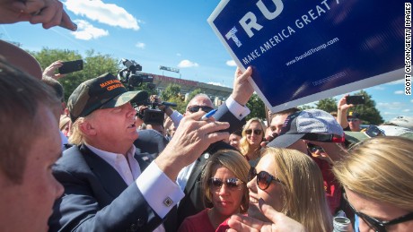 Republican presidential candidate Donald Trump greets fans tailgating outside Jack Trice Stadium before the start of the Iowa State University versus University of Iowa football game on September 12, 2015 in Ames, Iowa.