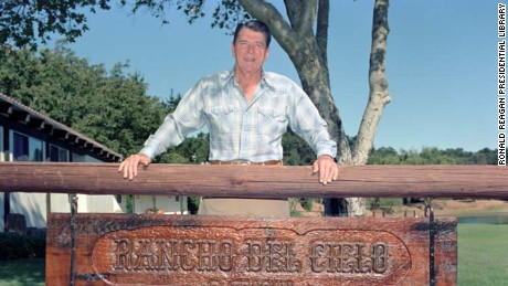 President Reagan standing above his ranch sign at Rancho Del Cielo on August 30, 1986.