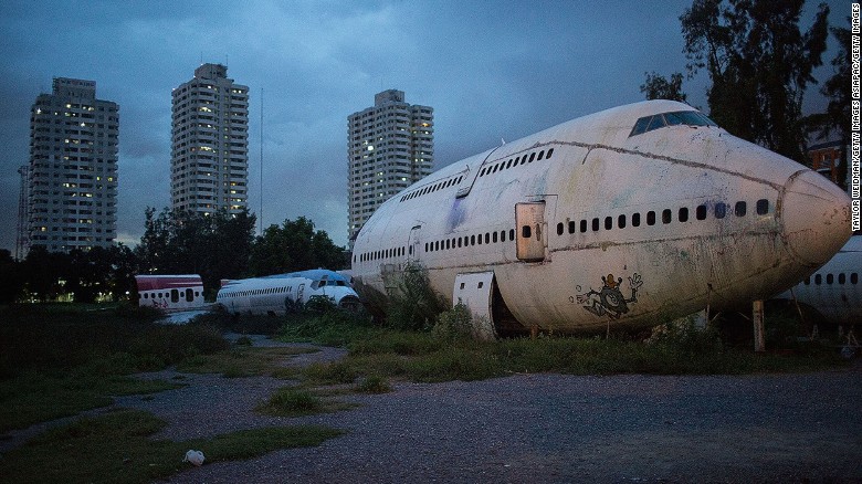 BANGKOK, THAILAND - SEPTEMBER 12:  Disused airplanes sit in a lot on September 12, 2015 in Bangkok, Thailand. 3 impoverished Thai families have begun living in disused airplanes on a private field. The families, who collect and recycle garbage earning a few dollars a day, can't afford to rent and prefer to stay in the planes.  (Photo by Taylor Weidman/Getty Images)