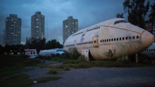 BANGKOK, THAILAND - SEPTEMBER 12:  Disused airplanes sit in a lot on September 12, 2015 in Bangkok, Thailand. 3 impoverished Thai families have begun living in disused airplanes on a private field. The families, who collect and recycle garbage earning a few dollars a day, can't afford to rent and prefer to stay in the planes.  (Photo by Taylor Weidman/Getty Images)