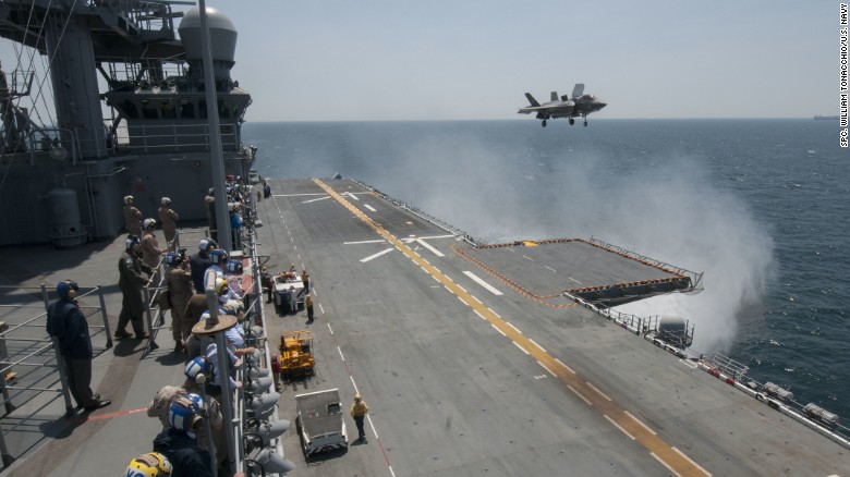 Sailors and distinguished visitors watch an F-35B Lightning II aircraft conduct vertical takeoff and landing flight operations aboard the amphibious assault ship USS Wasp in May. Click through the gallery to see more images from the testing.