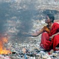 Hyderabad, INDIA: An Indian mother and her son burn waste in order to retrieve the copper wire at the garbage dump in the Borabanda slum in Hyderabad, 05 June 2007, on the occasion of World Environment Day. World Environment Day, commemorated each year 05 June, is one of the principal vehicles through which the United Nations stimulates worldwide awareness of the environment and enhances political attention and action.   AFP PHOTO / NOAH SEELAM (Photo credit should read NOAH SEELAM/AFP/Getty Images)