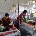 A doctor attends to dengue patients in a pediatric ward at New Delhi's Hindu Rao hospital. 