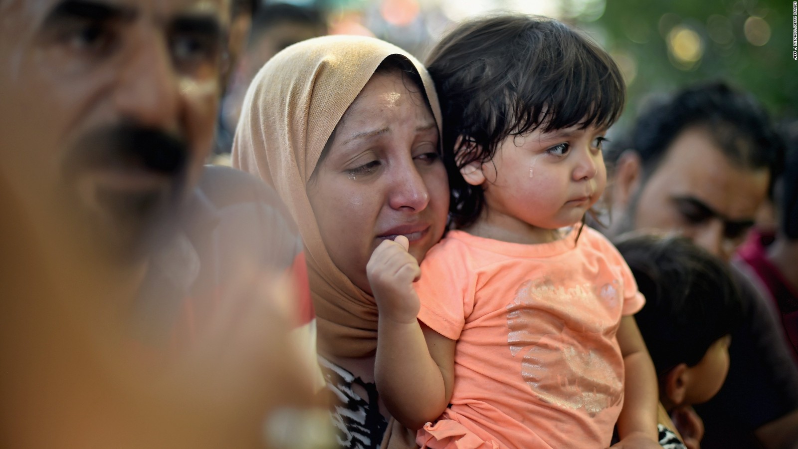 A woman and child wait at Tovarnik station for a train to take them to Zagreb on September 17, 2015 in Tovarnik, Croatia.