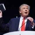 Republican presidential candidate, businessman Donald Trump holds a Bible as he speaks during the Iowa Faith & Freedom Coalition's annual fall dinner, Saturday, Sept. 19, 2015, in Des Moines, Iowa. (AP Photo/Charlie Neibergall)