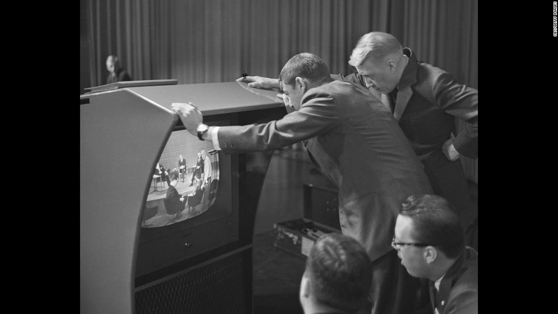 Stanton, right, and producer Don Hewitt check a television monitor before the debate.