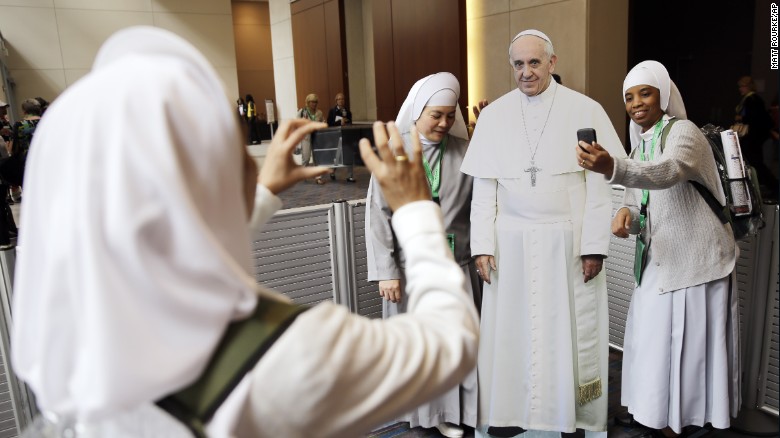 Nuns pose for a selfie with a Pope Francis cutout at a conference in Philadelphia on September 22.