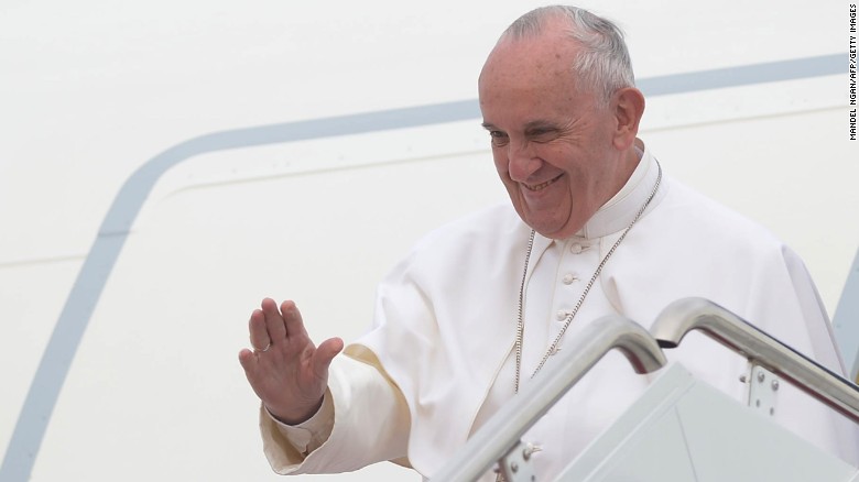 The Pope waves at Obama and his family.
