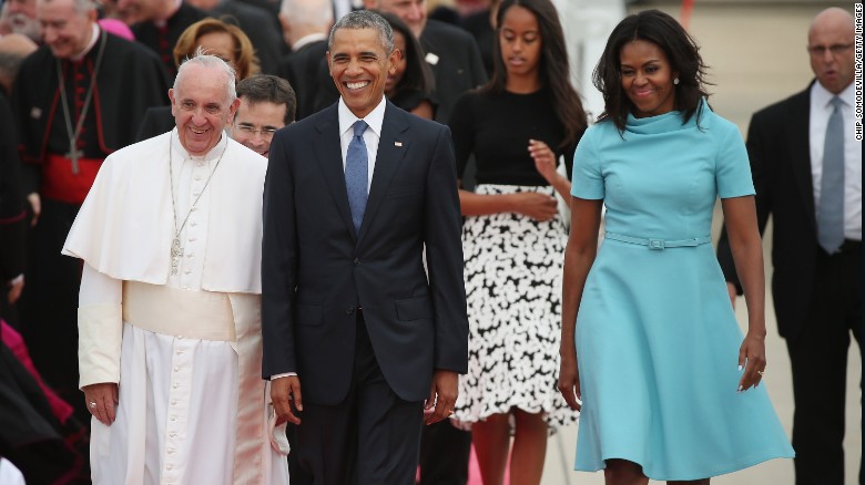Pope Francis is escorted by the Obamas and their daughters after arriving in the country.