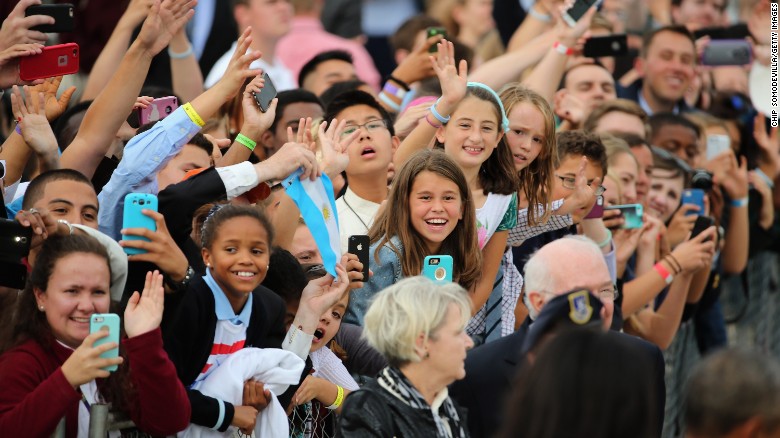 People cheer for Pope Francis at the Air Force base.