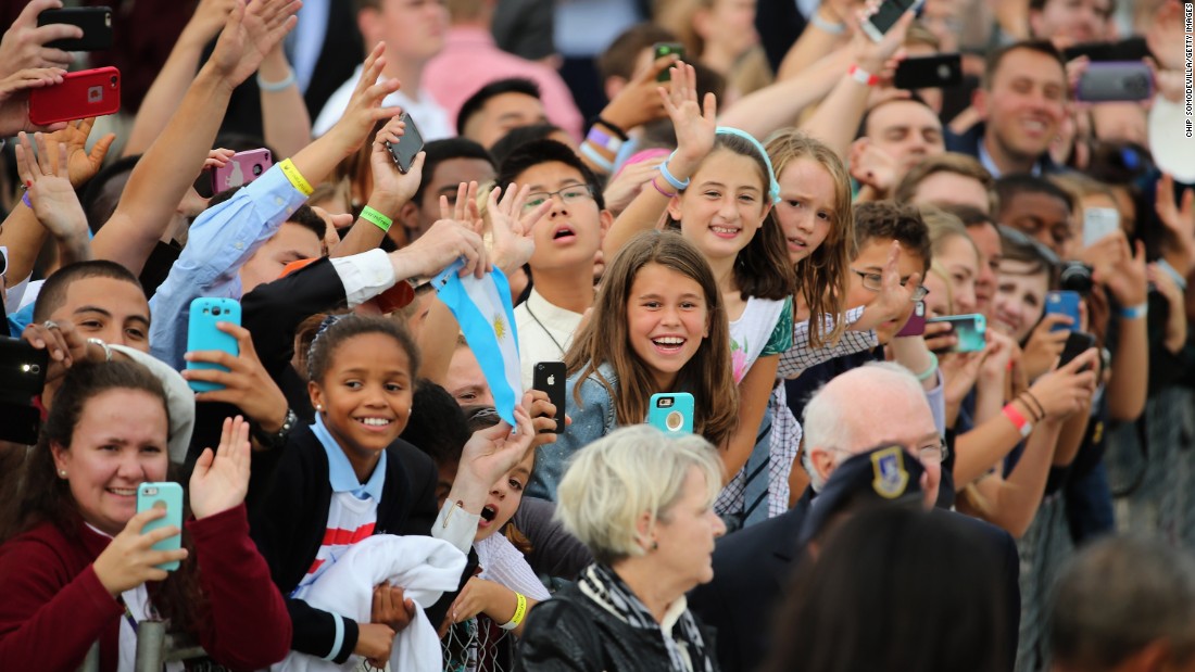 People cheer for Pope Francis at the Air Force base.