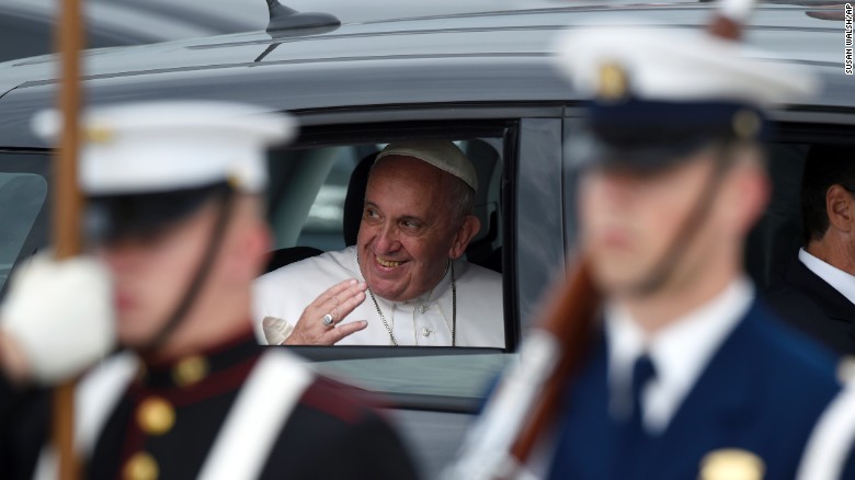 Pope Francis waves from his car at Andrews Air Force Base.