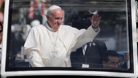 Pope Francis waves to the crowd from the popemobile during a parade in Washington, Wednesday, Sept. 23, 2015, following a state arrival ceremony hosted by President Barack Obama at the White House. (AP Photo/Alex Brandon, Pool)