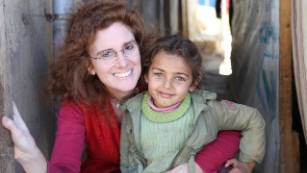 Barbara Massaad poses with a refugee child at the Zahle Lebanon. Her experience at the camp inspired her to create the humanitarian cookbook "Soup for Syria."
