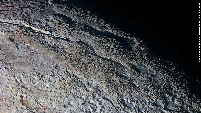 These photos show Pluto&#39;s variety of textures -- including what NASA calls &quot;rounded and bizarrely textured mountains.&quot; The mountains are informally called the Tartarus Dorsa. This image shows about 330 miles (530 kilometers) of Pluto&#39;s terrain. It combines blue, red and infrared images taken by the space probe&#39;s Ralph/Multispectral Visual Imaging Camera. The images were taken on July 14, 2015, during the probe&#39;s flyby. They were released on September 24, 2015.