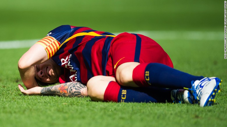 Lionel Messi lays injured on the pitch during the La Liga match between FC Barcelona and Las Palmas at the Nou Camp.