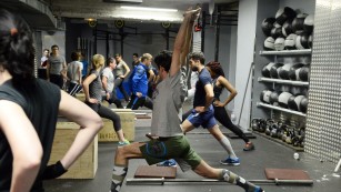 TO GO WITH AFP STORY BY FRANCOISE CHAPTAL
People take part in a crossfit training in a gym in Paris on January 16, 2015. AFP PHOTO / BERTRAND GUAY        (Photo credit should read BERTRAND GUAY/AFP/Getty Images)