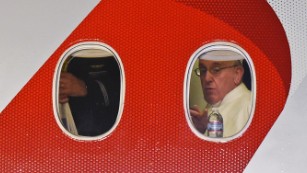 Pope Francis looks out the window a plane as he prepares to depart Philadelphia International Airport in Philadelphia, Sunday, Sept. 27, 2015, on his way back to Rome. Pope Francis wrapped up his 10-day trip to Cuba and the United States on Sunday. (AP Photo/Susan Walsh)