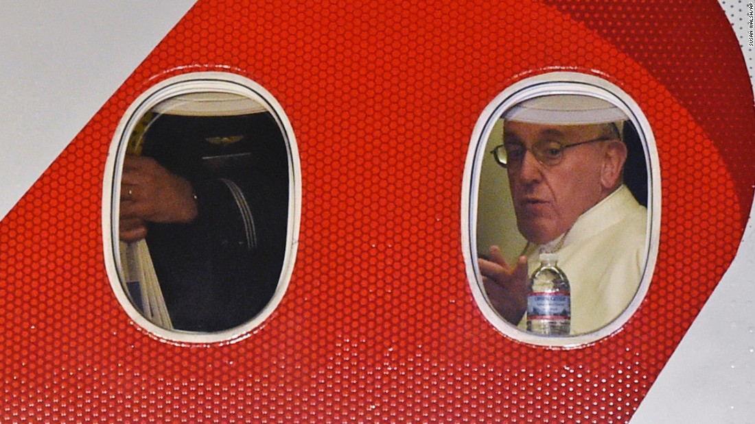 Pope Francis looks out the window a plane as he prepares to depart Philadelphia International Airport in Philadelphia, Sunday, Sept. 27, 2015, on his way back to Rome. Pope Francis wrapped up his 10-day trip to Cuba and the United States on Sunday. (AP Photo/Susan Walsh)