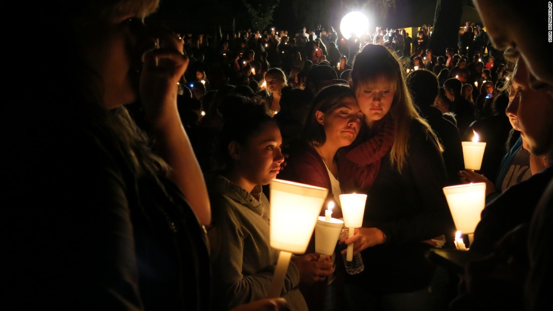 Community members attend a candlelight vigil at Stewart Park for those killed during a shooting at Umpqua Community College in Roseburg, Oregon, on Thursday, October 1. The massacre left nine people dead and nine wounded. The gunman also died.
