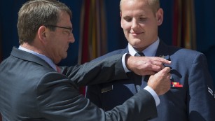 Airman 1st Class Spencer Stone, right, receives the Airman&#39;s Medal from Defense Secretary Ashton Carter in Washington on September 17 for his role in disarming a gunman on a Paris-bound train in August.