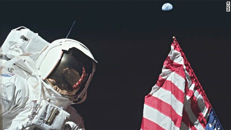 AS17-134-20384 (7-19 Dec. 1972) --- Scientist-astronaut Harrison H. Schmitt, lunar module pilot, is photographed next to the deployed United States flag during lunar surface extravehicular activity (EVA) at the Taurus-Littrow landing site. The highest part of the flag appears to point toward our planet Earth in the distant background. This picture was taken by astronaut Eugene A. Cernan, Apollo 17 commander. While astronauts Cernan and Schmitt descended in the Lunar Module (LM) to explore the moon, astronaut Ronald E. Evans, command module pilot, remained with the Command and Service Modules (CSM) in lunar orbit.